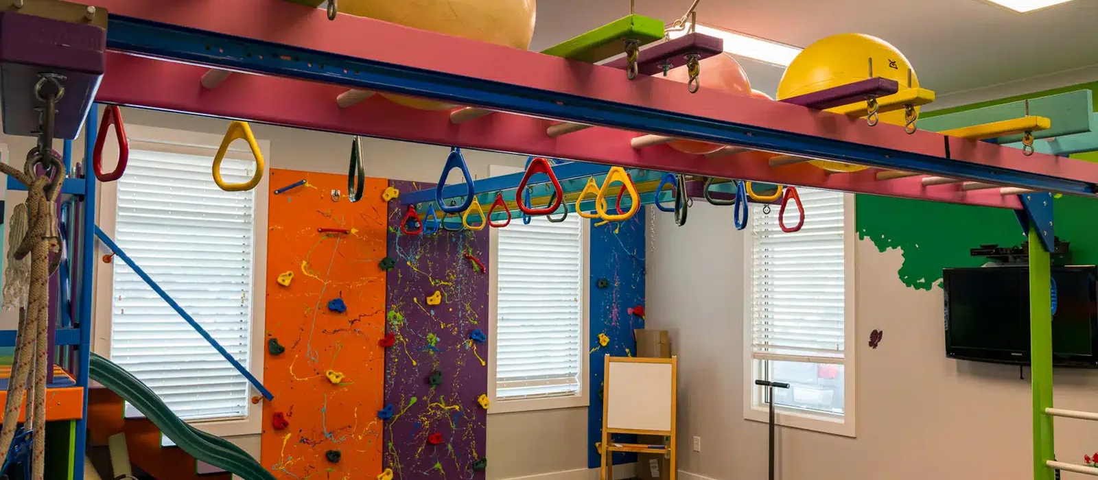 The sensory gym at Hope Therapy Lafayette with a climbing wall and slide