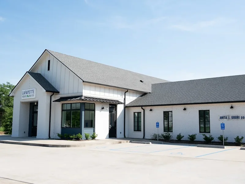 The white brick clinic building on Camellia Blvd with parking directly in front