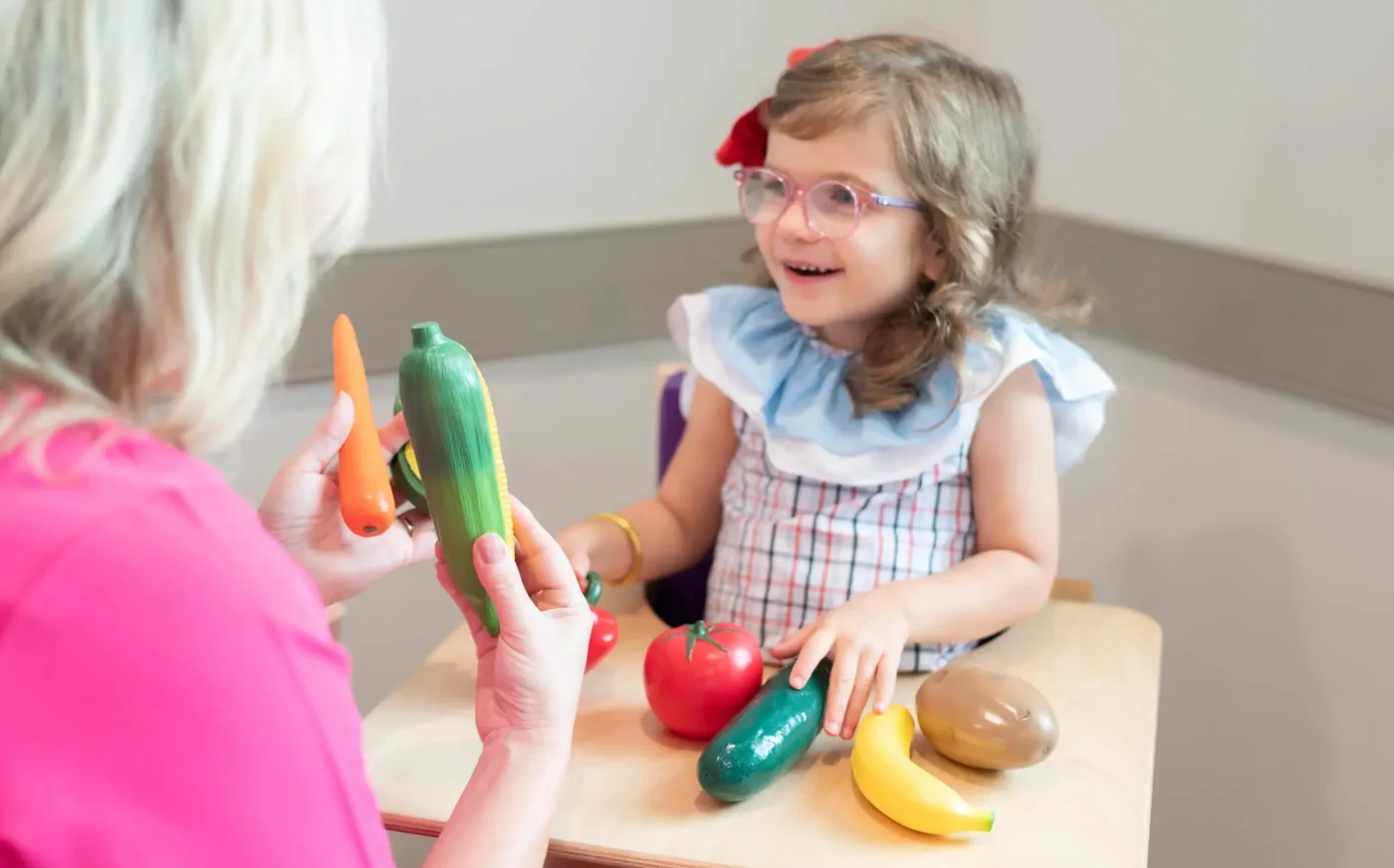 Speech therapist and a young child working with play food at Hope Therapy Lafayette