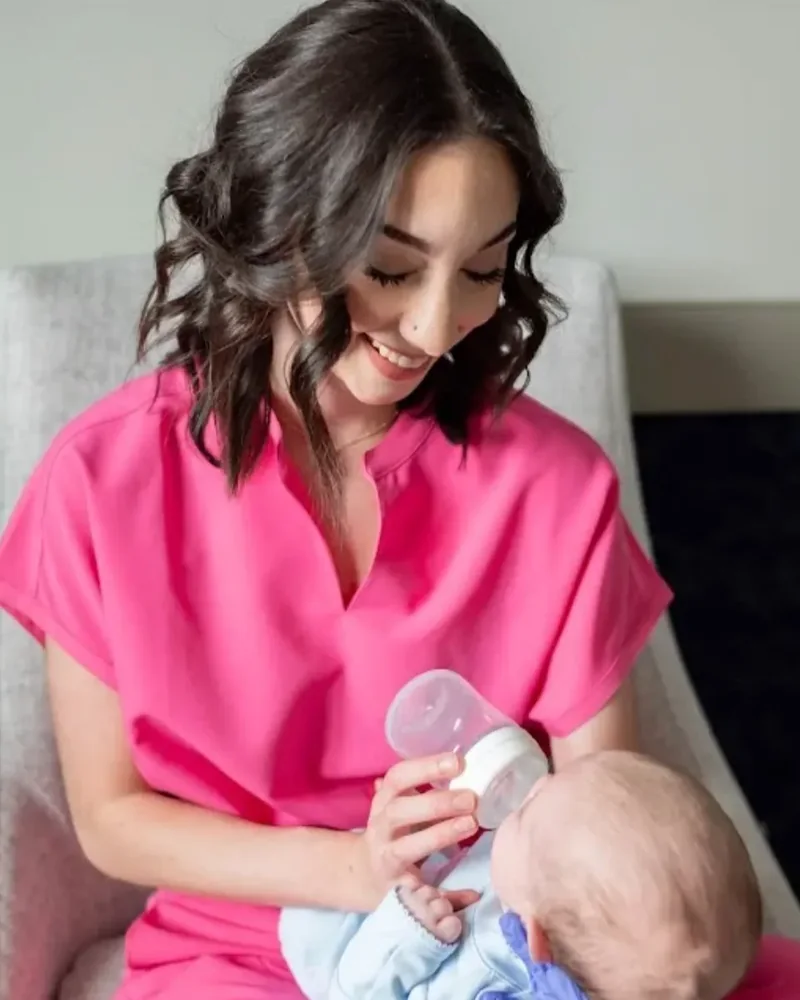 Therapist bottle feeding a newborn during a feeding session
