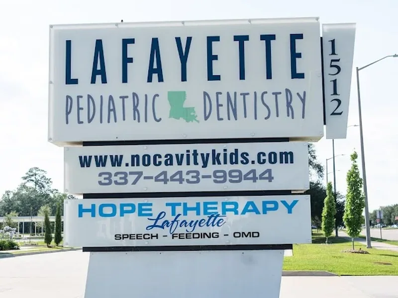 Street sign at 1512 Camellia Blvd showing Lafayette Pediatric Dentistry above the Hope Therapy Lafayette panel