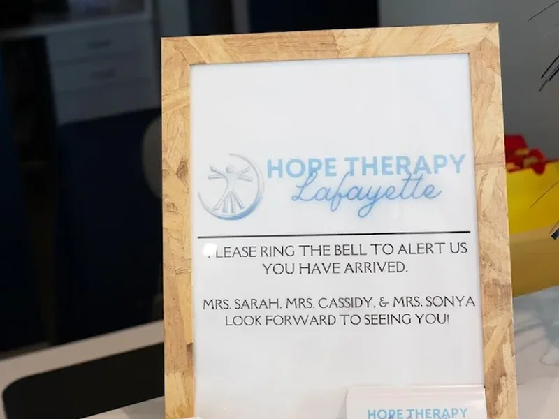 Framed welcome sign on the front desk asking families to ring the bell when they arrive