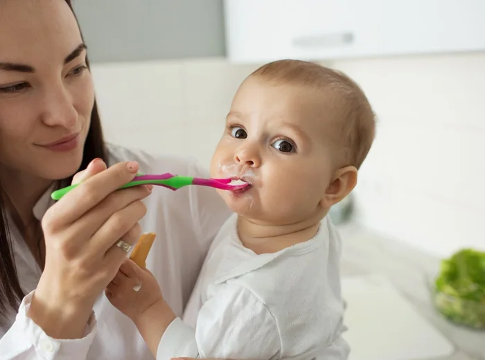 Therapist assessing a baby's oral movement during a feeding visit